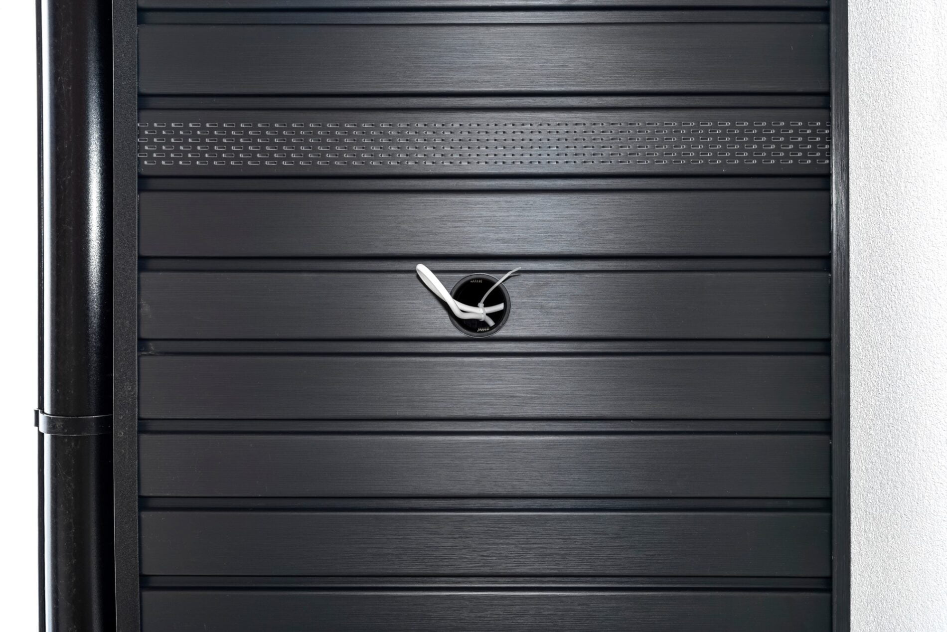 The image depicts a contemporary architectural scene featuring a modern graphite-coloured roof lining. The structure is shown under construction or in a newly completed state. The roof lining material appears to be sleek and smooth, with panels that fit together seamlessly, demonstrating a high level of craftsmanship and attention to detail. The graphite tone of the roof enhances the modern aesthetic, blending functionality with stylish design.

In the background, part of the building's external wall is visible, constructed from light-coloured materials that contrast beautifully with the dark roof lining. This juxtaposition of colours adds depth and visual interest to the overall design. The weather appears clear with ample daylight, suggesting that the photo was taken during daytime. There are no visible architectural flaws or inconsistencies, which indicates that the work has been carried out meticulously. The image captures not just the physical attributes of the roof lining but also conveys a sense of modernity and sophistication.